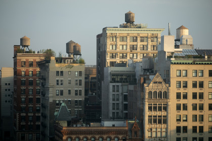 Several tall residential buildings in NoHo, New York City, draped by sunlight.