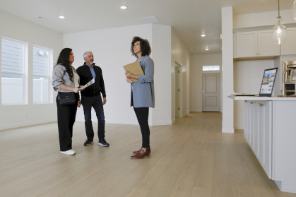 Real estate broker showing apartment to prospective buyers