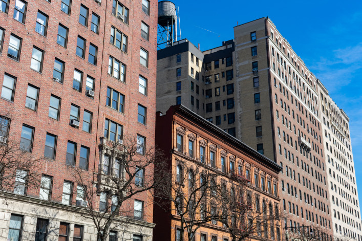 Row of Colorful Old Brick Residential Buildings and Skyscrapers in Morningside Heights of New York City