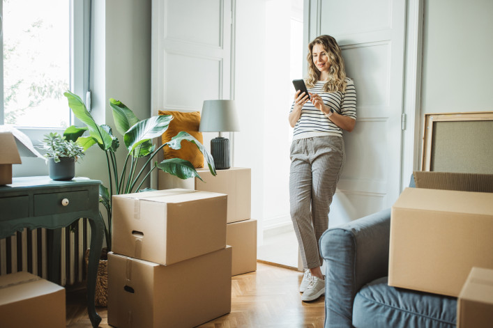 A woman with packed moving boxes