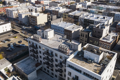 Air conditioners mounted on a rooftop. Residential district of Bushwick, Brooklyn, New York. - stock photo