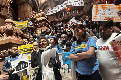 Tenant reform advocates with banners calling for good cause eviction laws in Albany