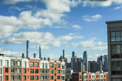 The NYC skyline as seen behind new apartment buildings.