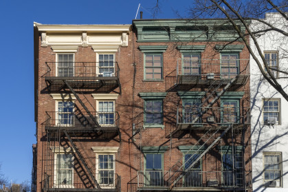 Classic exterior metal fire escapes on or near Greenwich Street in New York City.