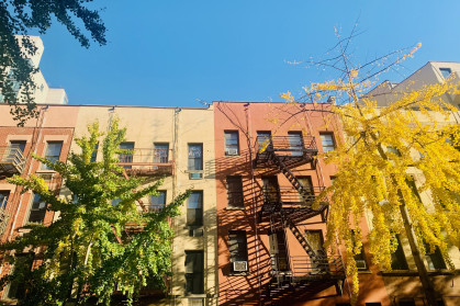 brightly colored apartment buildings surrounded by trees in Upper East Side, Manhattan