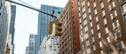 Yellow traffic light with NYC buildings in the background