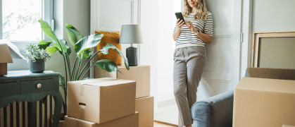 A woman with packed moving boxes