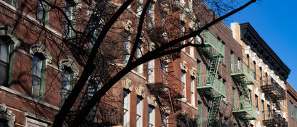 Row of Colorful Old Brick Residential Buildings with Fire Escapes in Greenwich Village of New York City stock photo