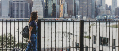 Young woman travelling in New York with suitcase