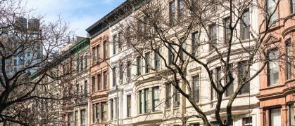 A Manhattan street of traditional apartment buildings.