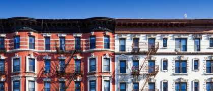 New York City old historic apartment building in the East Village of Manhattan, NYC with a clear blue sky background