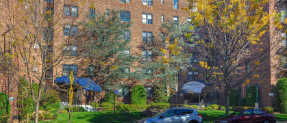 Large 6 Story Red Brick Co-op Apartment Building on Shore Road in Bay Ridge Neighborhood of Brooklyn, New York, USA. SUV parked on the street in front of the building. Canon EOS 6D (full Frame Sensor) Camera and Canon EF 24-105mm F/4L IS Lens. HDR image.