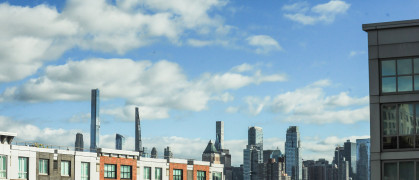 The NYC skyline as seen behind new apartment buildings.