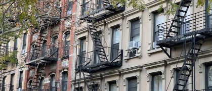 Old colorful buildings with fire ladder and trees on New-york manhattan, Upper East Side, buildings front house