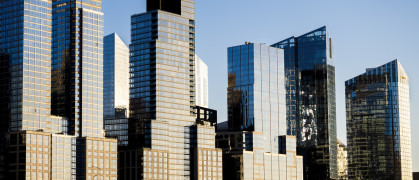 Glimmering steel and glass apartment buildings along the West Side Highway, south of the Henry Hudson Parkway, far west of Manhattan, New York City, on a sunny fall day. Skyline, NYC.