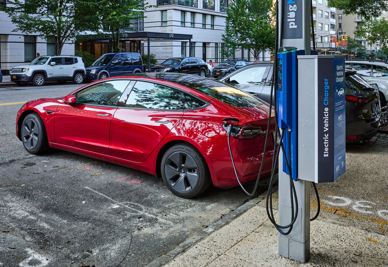 Recharging an electric car at a curbside NYC charger stock photo