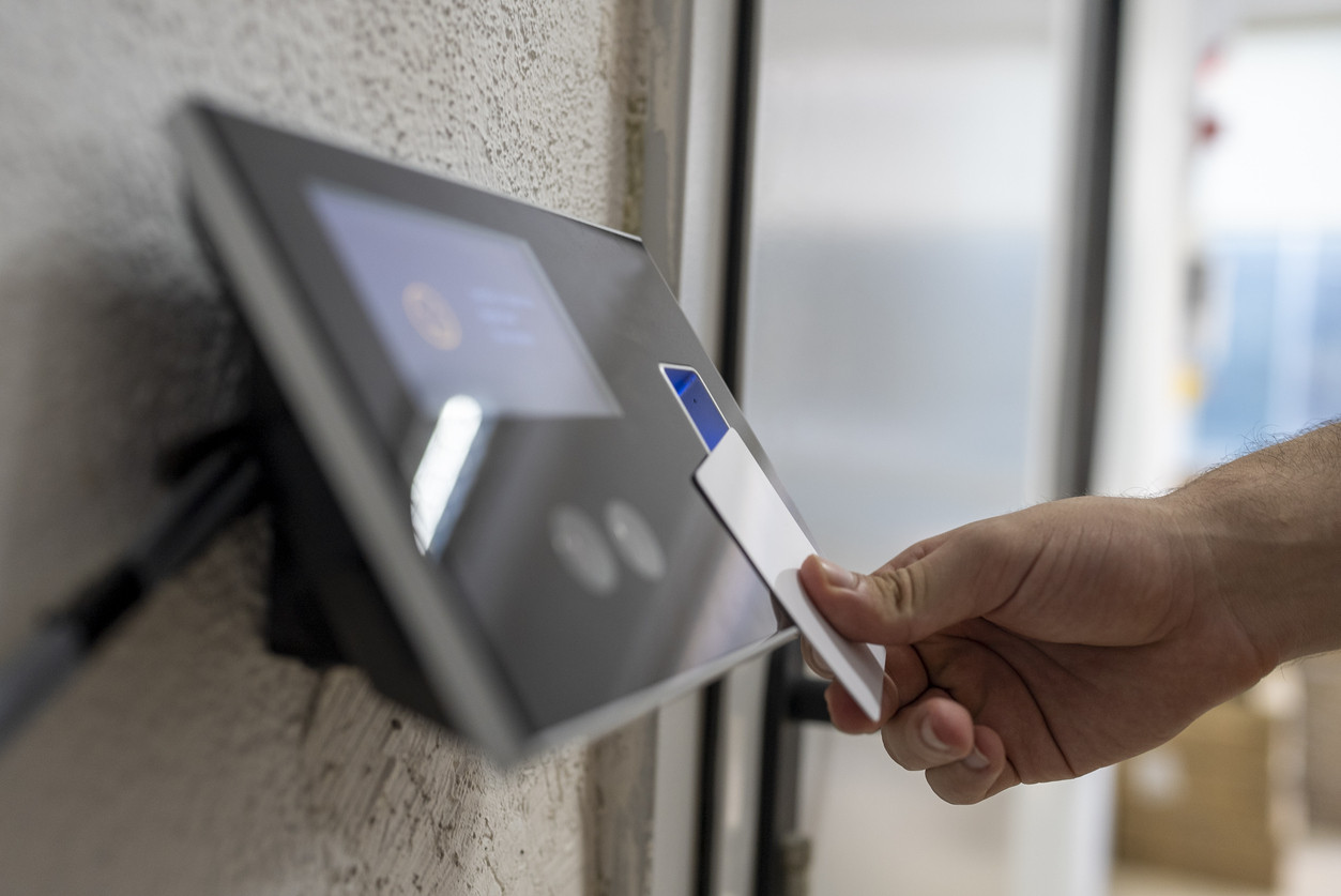 Male hand holding key card to accessing the room stock photo